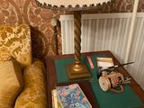 a small table with a lamp on top of it next to a couch