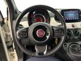 the interior of a small car with a steering wheel and dashboard controls