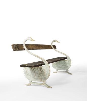 two swans that are sitting on a bench
