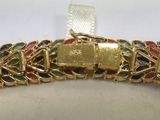 an image of a gold bracelet with multi colored stones on it