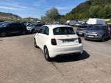 a white car parked in a parking lot next to other cars