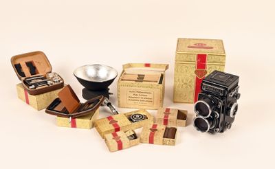 many different types of cameras and boxes on the table