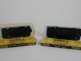 two toy trains sitting next to each other on a table