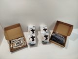 three boxes of electronic devices sitting on top of a white table