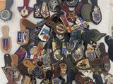 a pile of badges and other items on a table