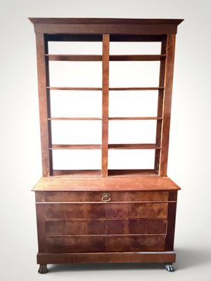 an image of a wooden bookcase with a drawer underneath it