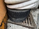 a pile of hoses stacked on top of a pile of tires