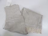 two pieces of linen with lace on them sitting on a table