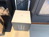 a small wooden box sitting on the floor next to a stove