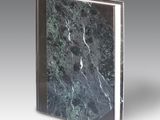 an image of a book with a marble cover on a gray background