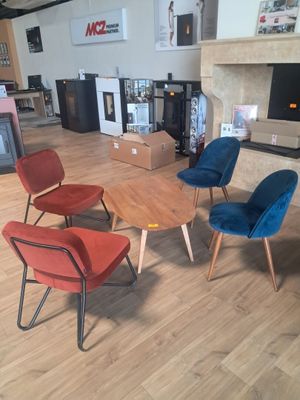 four chairs and a table in the middle of a room