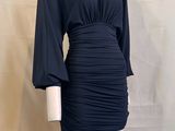 the mannequin is wearing a black dress and white tights