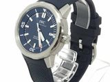 a watch with a blue dial and black rubber band