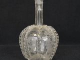 an old fashioned glass bottle with a crown on the top of it