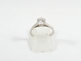 a close up of a diamond ring on a white surface