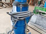 a blue machine that is on a cart in a warehouse