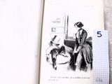 une photo d'un livre sur lequel figure le dessin d'une femme et d'un chien