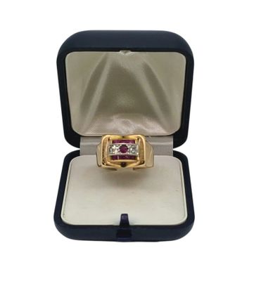 a close up of a ring in a box on a white surface