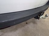 a close up of a white car with a black bumper