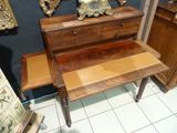 a small desk with a mirror on top of it