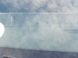 reflection of an apple logo on the windshield of a car
