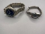 two watches that are sitting next to each other on a table