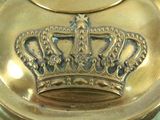 a gold plate with a crown on top of it