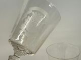 a glass with a bottle on it next to a glass with a bottle on it