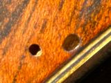 a close up of a piece of wood with holes in it