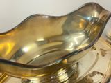 a glass bowl sitting on top of a silver plate