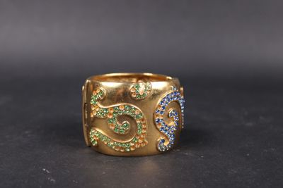 a close up of a gold ring with blue and green stones
