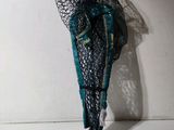 a mannequin dressed in a black and teal outfit