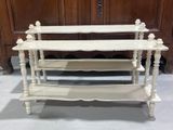 a white shelf with three shelves on top of it