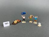 a lot of miniature figurines that are on a table