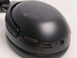 a close up of a black mouse with a black cord