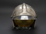 a silver helmet on a stand on a black background