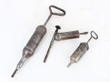 three different types of tools sitting on top of a white surface