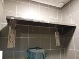 a towel hanging on a shelf in a bathroom