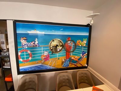 a picture of a dining room with a painting on the wall