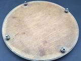 a metal plate with screws on a black table
