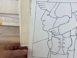 a person holding a piece of paper with a drawing on it