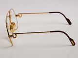 glasses on a white surface with a pair of gold rims