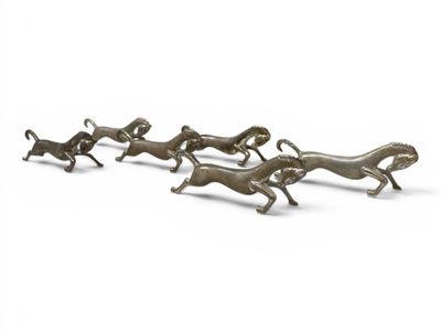 a group of bronze figurines of running dogs on a white background