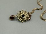 gold plated necklace with a black stone pendant and a gold chain