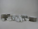 a lot of dishes and cups on the table