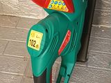 a green and red gas pump with a price tag on it