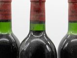 three bottles of wine sitting on top of a table next to each other