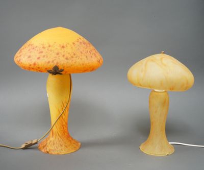 two yellow and orange mushroom shaped lamps on a gray surface