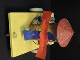 a red and yellow object on a black surface
