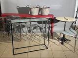 a red table and chairs in a room with a white wall